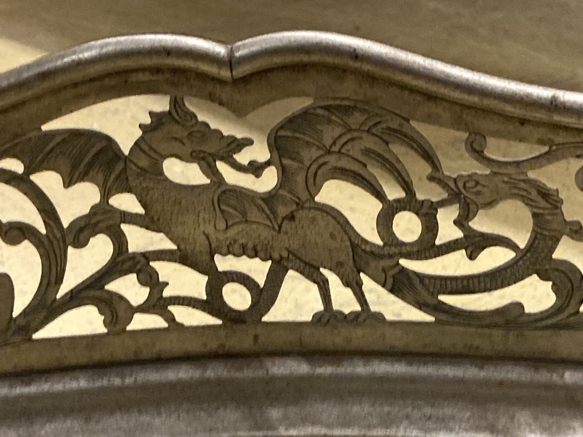 A George III pierced steel serpentine fender, length 130cm, together with a pair of wrought iron firedogs